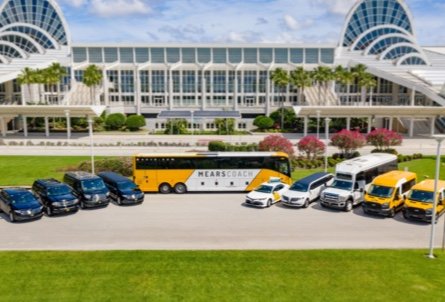 Mears black luxury sedan, SUV, van and limousine, Mears yellow and white Motorcoach bus, Mears yellow and white taxi sedan and van, Mears white limo, Mears white mini bus, and Mears yellow shuttle outside the Orlando Convention Center in Orlando, Florida